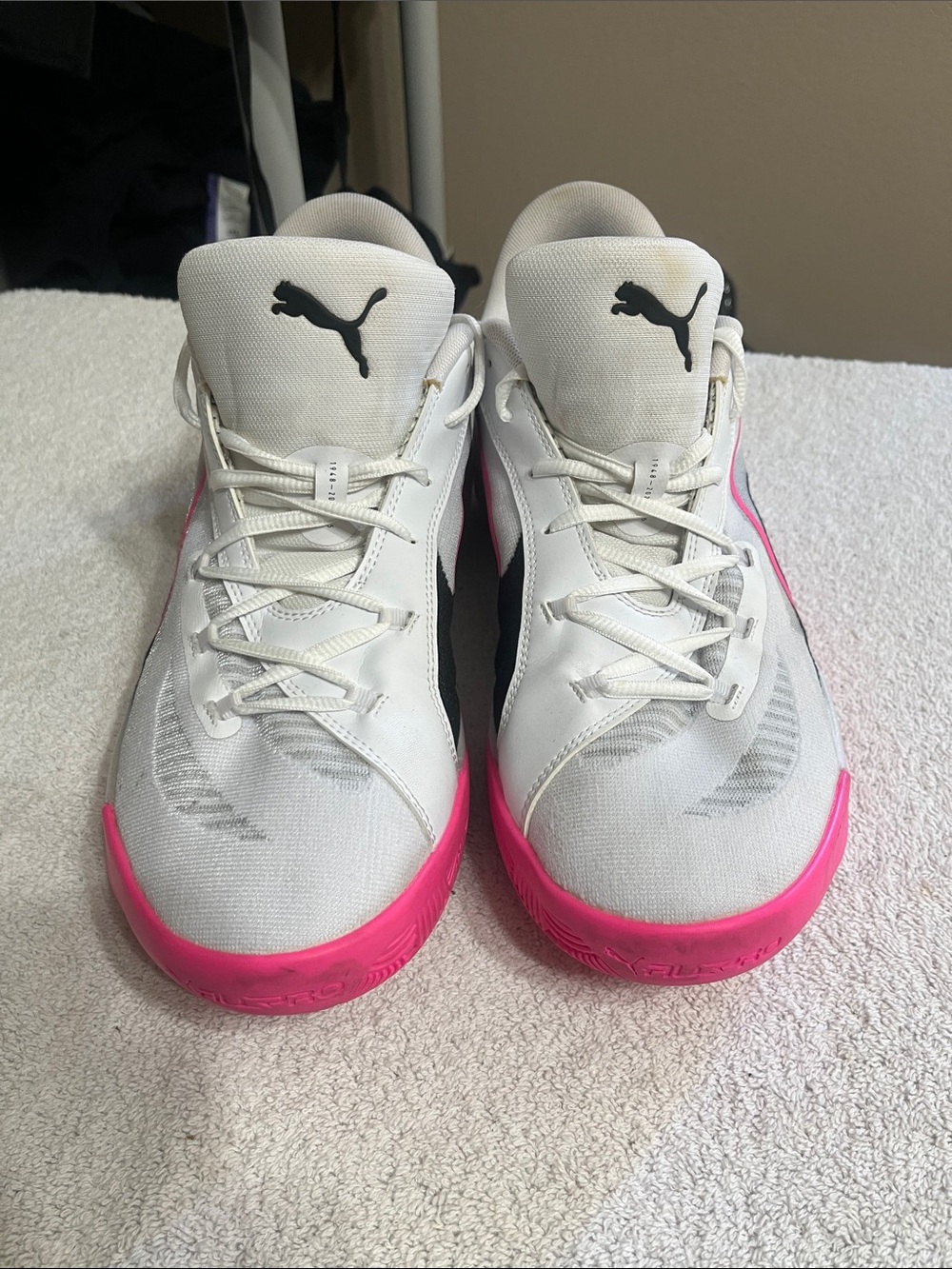 Puma White Sneakers with Pink Outsoles and Black Logo